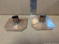 Pair of octagonal copper candle holders showing size and condition
