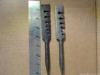 Two slotted saw tooth wrests with ruler for scale, showing slot profiles and pointed handles