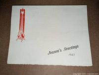 Front cover showing red decorative banner, Season’s Greetings 1943 text