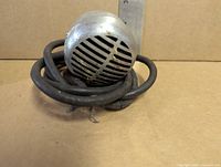 Front view showing grille and coiled cut cable