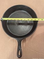 Top view of skillet with tape measure showing 11-inch diameter