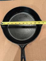 Top view of skillet with tape showing approximately 11-inch diameter