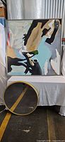 framed abstract painting and round mirror full view