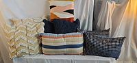 Group shot of six pillows showing variety of colours, patterns and shapes