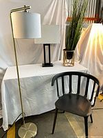 All items grouped: brass floor lamp, table lamp, chair, artificial plant