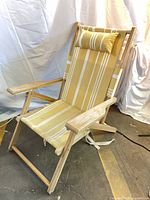 Front view of teak reclining chair upright with pillow