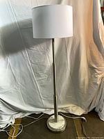 Entire lamp showing shade, pole, marble base