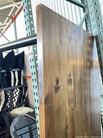 Edge view of wooden tabletop showing grain and finish