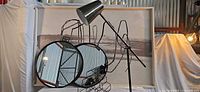 Group shot of artwork, lamp, mirrors, rack