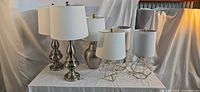 Group of six lamps on table