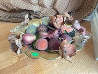 Top view of hammered brass bowl with faux fruit and flowers