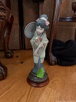 Front view of Lladró geisha figurine on stand