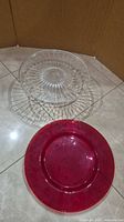 Top view showing both the red charger plate and clear pedestal cake stand