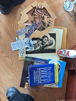 Lot overview; books, prints, plaque, candle, bookmark visible