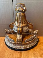 Front view of ornate gilded wall bracket shelf