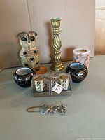 Full lot overview showing owl lantern, candlestick, votive holders, packaged candles, pillar candle, seashell ornament