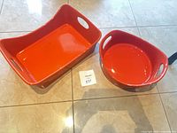 Rectangular and round orange ceramic dishes side by side