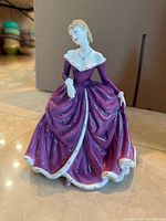 Front angled view of Belle figurine showing gown detail and overall condition