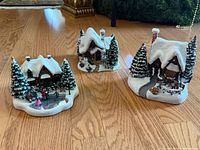 All three ceramic Christmas village cottages grouped on floor