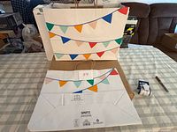 Front and back of Spritz gift bag showing pennant banner design and handle