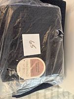 Stack of sealed Threshold Total Fresh bath mats with label visible