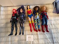 Five dolls lined up for full view