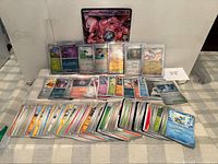 Overall view of jumbo Mewtwo ex card and spread of standard cards