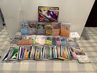 All cards spread out on table showing variety and jumbo card at back