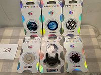 All six packaged PopSockets items on table