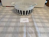 Side view of casserole with lid, pattern visible, size reference card