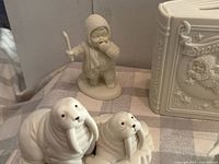 Group view: book plaque, child with stick, walrus duo