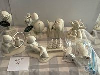 Group shot of all Snowbabies figurines on table