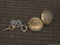 Pocket watch open with key and chain