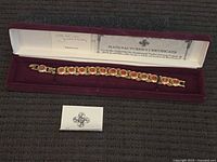 Bracelet in open presentation box with certificate and booklet