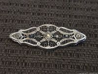 Front view of sterling filigree brooch showing stones and design