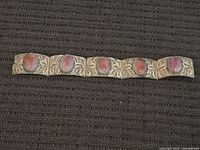 Full view of six-panel 800 silver filigree bracelet with pink cabochons