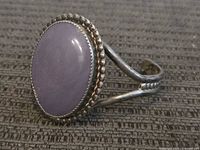 Front view showing oval lavender stone and beaded bezel on sterling split-shank cuff