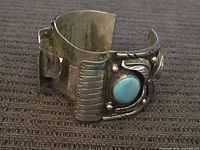Full view of sterling cuff showing turquoise cabochon and missing stone bezel