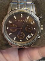 Close-up of Michael Kors wristwatch showing dial, crystals, sub-dials and beaded bezel