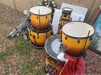 Full set showing five Pearl sunburst drums and collapsed hardware
