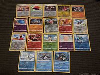 Entire 5×4 grid of 20 Pokémon cards shown on carpet