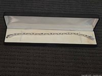 Full view of sterling silver tennis bracelet in presentation case
