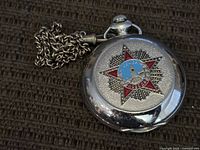 Front of pocket watch showing red star Pobeda emblem