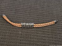Full view of braided leather bracelet with sterling slides