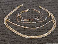 All four tri-color sterling silver necklaces laid out