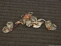 Brooch and earrings full set on textured background