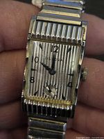 Front view of Bulova watch showing dial, case and bracelet