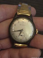 Front view of Bulova wristwatch showing dial, hands, numerals, subdial, and bracelet