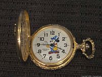 Open pocket watch showing dial, case, and broken latch area