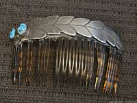 Full view of comb showing silver leaf overlay and tortoiseshell plastic teeth